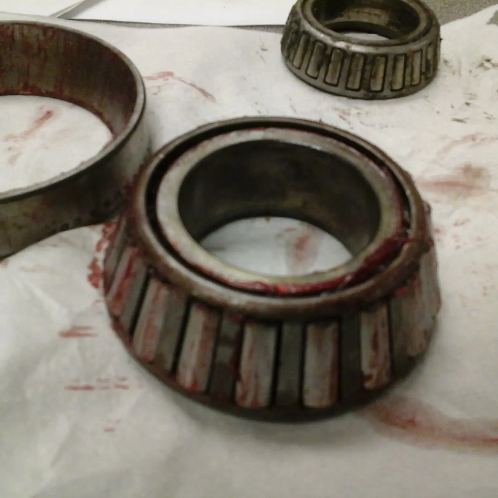 Used tapered roller bearing cone with its rollers, beside the outer ring