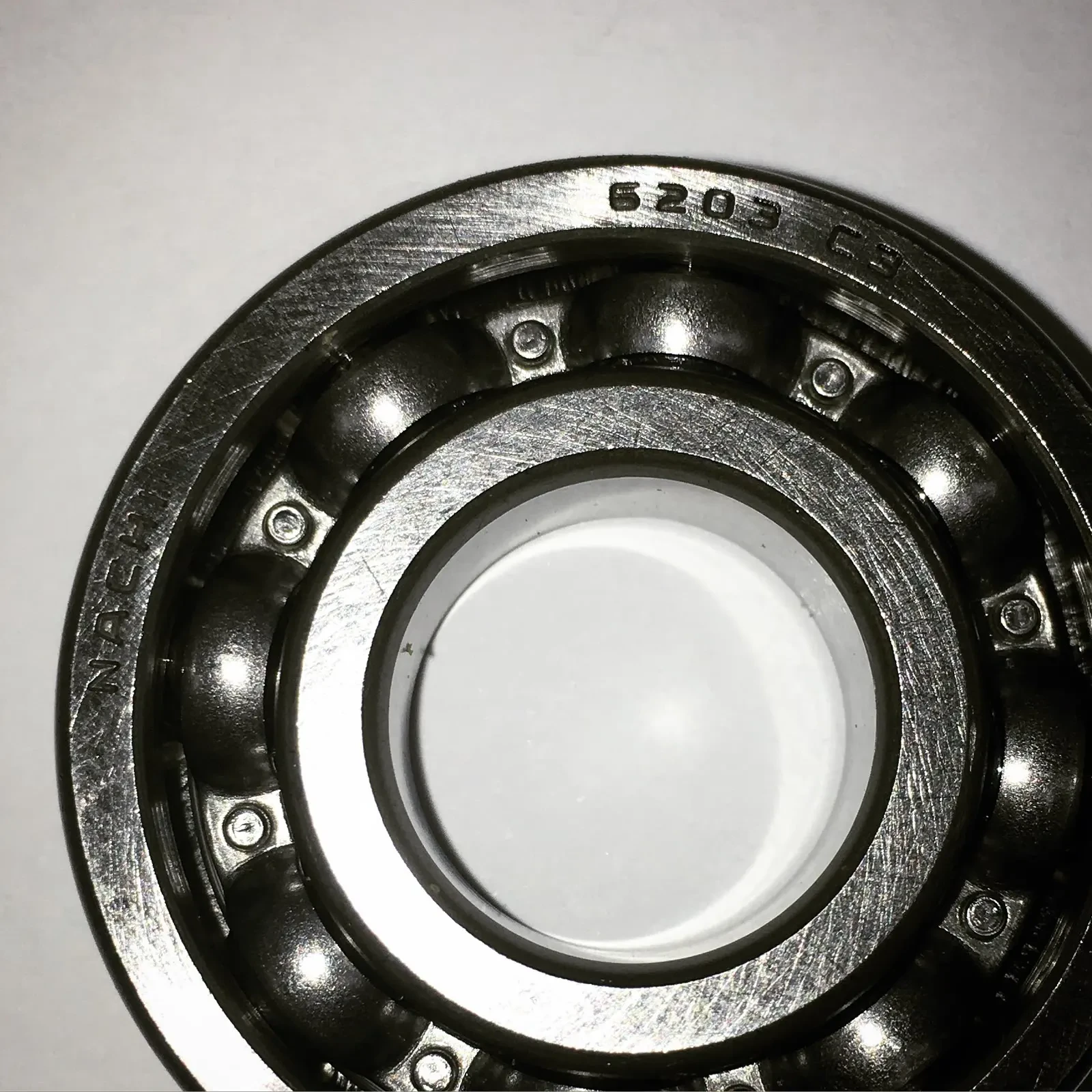 Close-up of a 6203 deep groove ball bearing showing the balls and cage